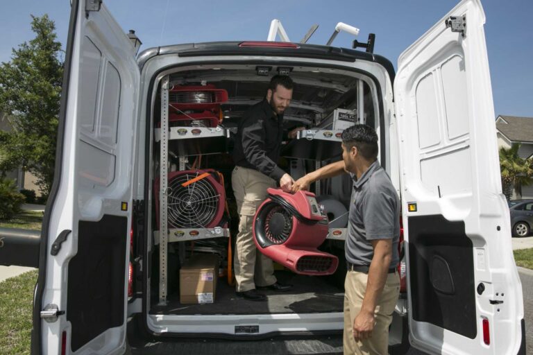 Paul Davis Restoration of the Space Coast storm damage restoration team unloading emergency drying and cleanup equipment from service van in Florida